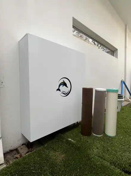 Dolphin enclosure against a rendered wall with replacement cartridges beside it