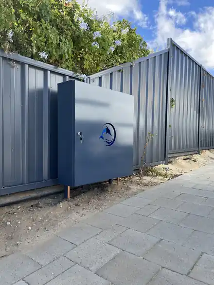Dolphin enclosure installed against a colorbond fence