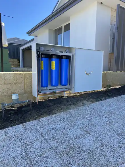 Dolphin filtration unit installed beside a house with the enclosure open