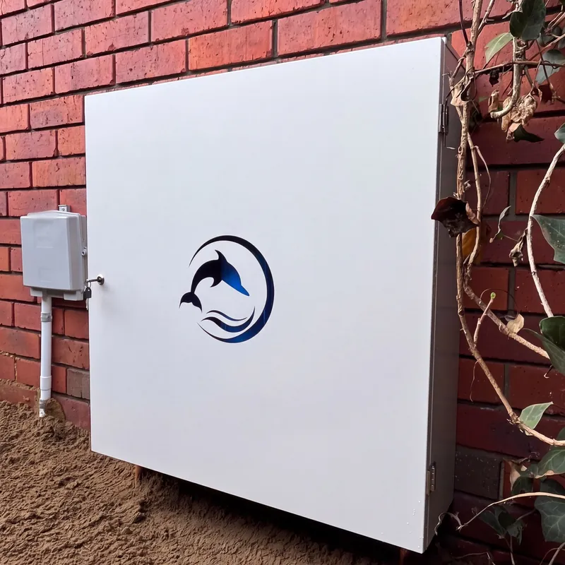 White powdercoated Dolphin enclosure on a red brick wall, with lock and key